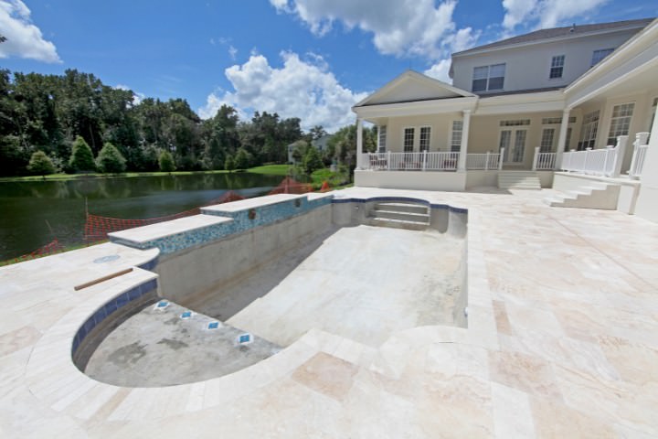 In-progress custom pool construction at a modern lakeside residence